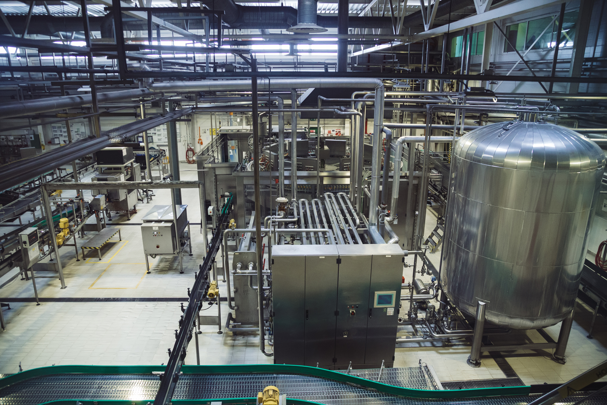 Modern brewery production line. Large vat for beer fermentation and maturation, pipelines and filtration system