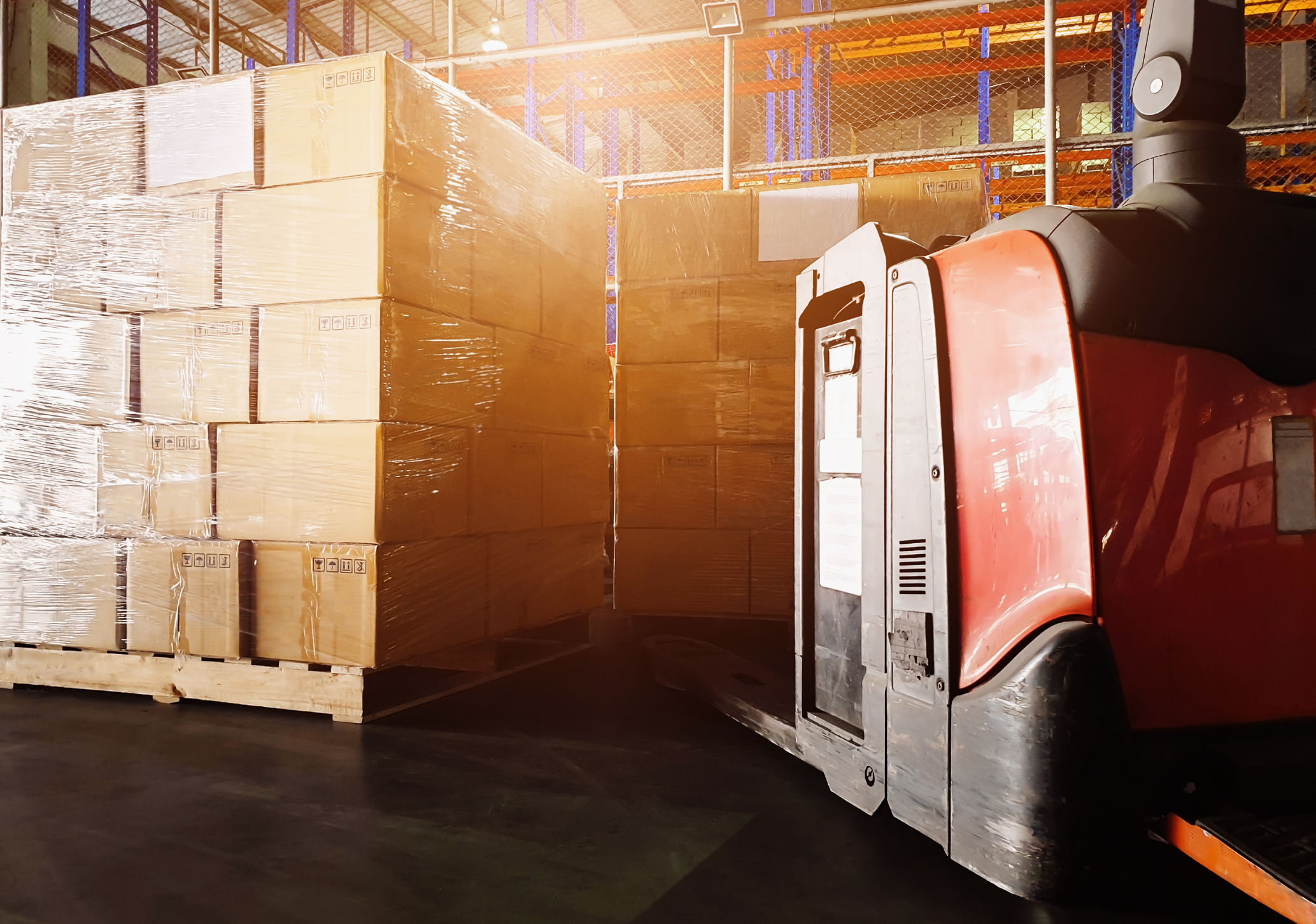 Interior of warehouse storage. electric forklift pallet jack with stack stack of shipment boxes on pallet. warehouse industry delivery shipment goods, logistics and transport